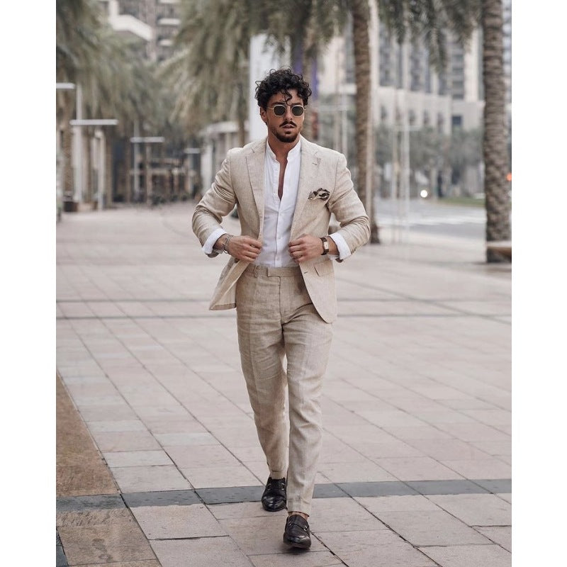 A man walking outdoors in a beige linen suit